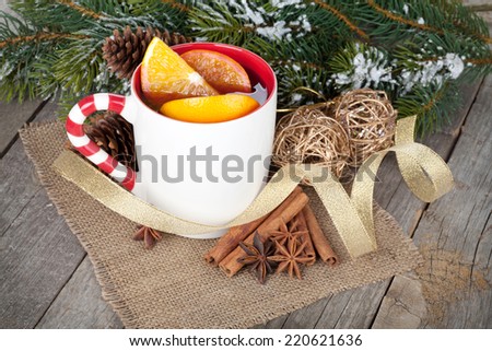 Christmas mulled wine with fir tree and decor on wooden table