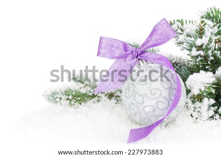 Christmas bauble and purple ribbon with snow fir tree. Isolated on white background with copy space