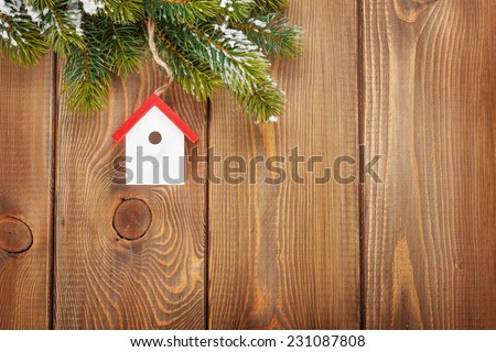 Christmas fir tree and birdhouse decor on rustic wooden board with copy space