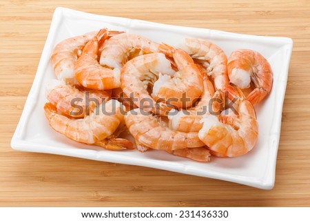 Cooked shrimps plate. On bamboo wooden table