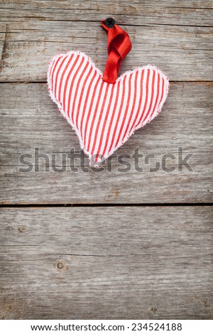 Red Valentine\'s day heart toy. On wooden background with copy space