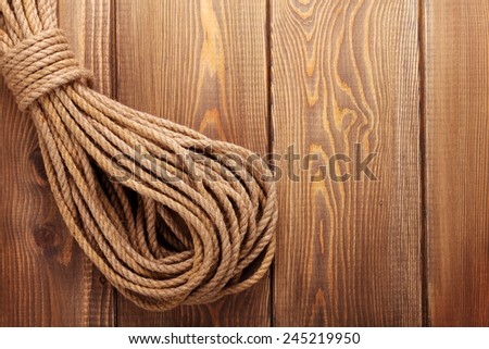 Wooden background with marine rope and copy space