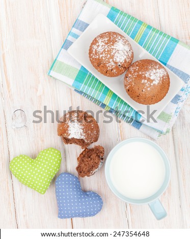 Cup of milk and cookies on white wooden table