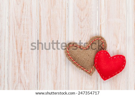 Valentines day background with toy hearts over white wooden table