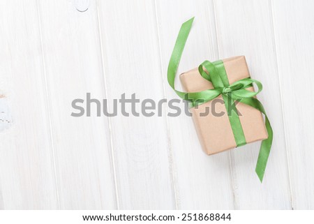 Gift box on wooden table background with copy space