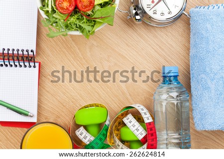 Healthy food, dumbells, tape measure and notepad for copy space. Fitness and health