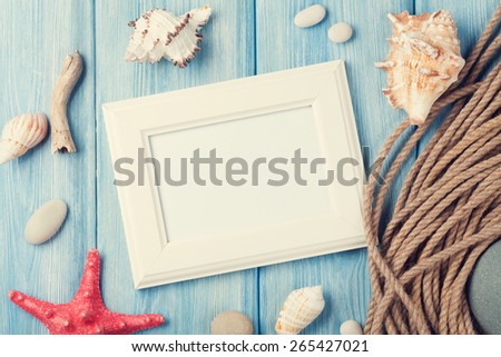 Summer time sea vacation with blank photo frame, star fish and marine rope. Retro toned