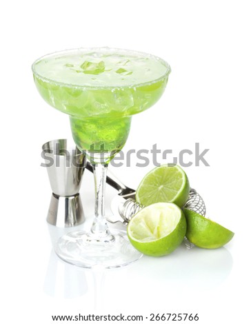 Classic margarita cocktail with salty rim with limes and drink utensils. Isolated on white background