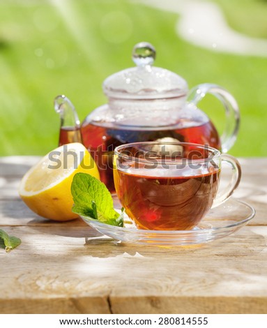 Breakfast tea on table in sunny garden