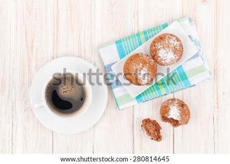 Homemade cakes and coffee cup on white wooden table. Top view