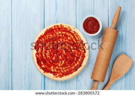 Pizza cooking on wooden table. Top view with copy space