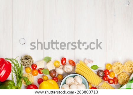 Italian food cooking ingredients. Pasta, vegetables, spices. Top view with copy space