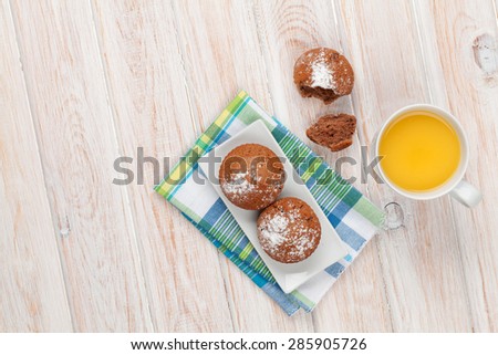 Homemade cakes and orange juice on white wooden table. Top view with copy space