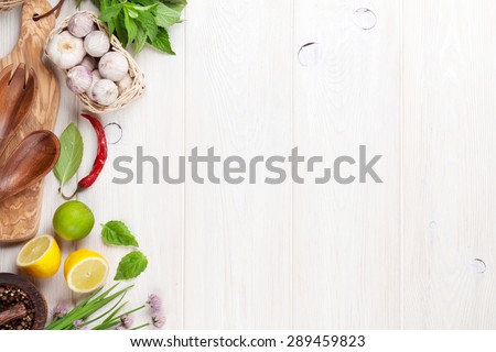 Fresh herbs and spices on wooden table. Top view with copy space