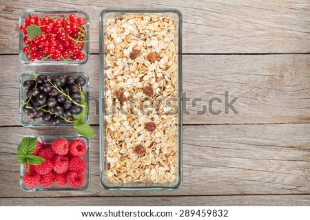 Healthy breakfast with muesli and berries. View from above on wooden table with copy space