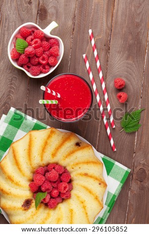 Raspberry smoothie, cake and berries on wooden table. Top view