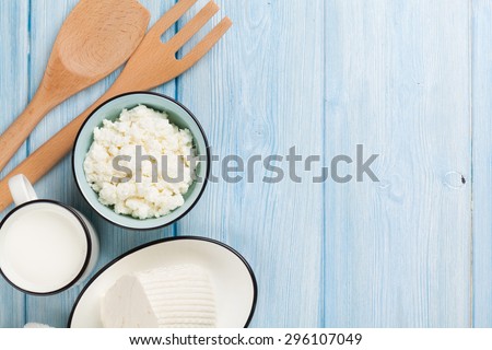 Dairy products on wooden table. Milk, cheese, curd cheese and butter. Top view with copy space