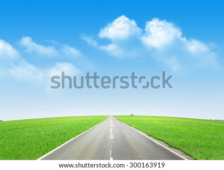Summer landscape with endless asphalt road through the green field and blue sky