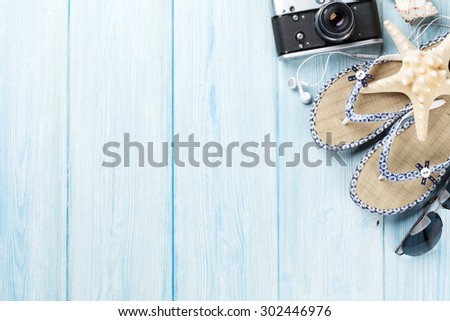 Travel and vacation items on wooden table. Top view with copy space