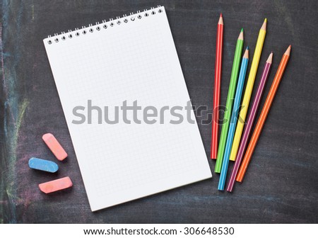 School and office supplies on blackboard background. Top view with copy space