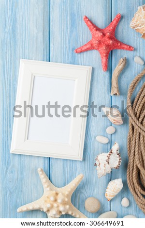 Summer time sea vacation with blank photo frame, star fish and marine rope