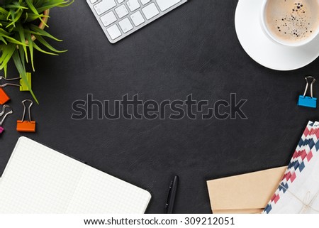 Office leather desk table with computer, supplies, coffee cup and flower. Top view with copy space
