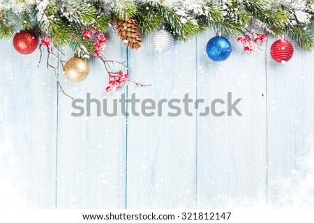 Christmas wooden background with snow fir tree and decor. View with copy space