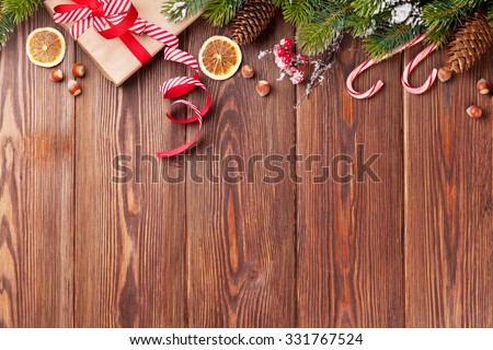 Christmas gift box, food decor and fir tree branch on wooden table. Top view with copy space