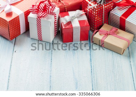 Christmas gift boxes on wooden table with snow. View with copy space