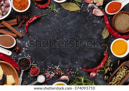 Herbs, condiments and spices on stone background. Top view with copy space