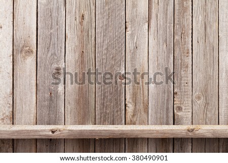 Wood shelf in front of wooden wall. View with copy space