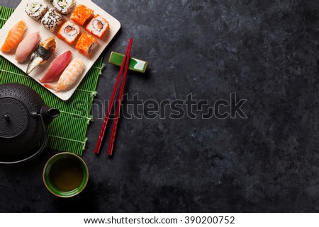 Set of sushi, maki and green tea on stone table. Top view with copy space