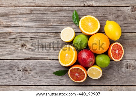 Fresh ripe citruses. Lemons, limes and oranges on wooden table. Top view with copy space