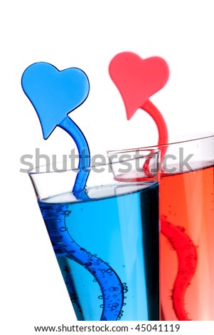 Two champagne alcohol cocktails with heart decoration. Isolated on white background