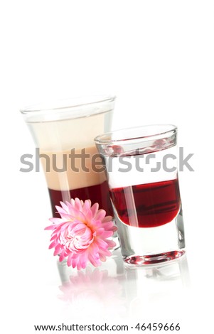 Two layered shot cocktails with flower isolated on white background