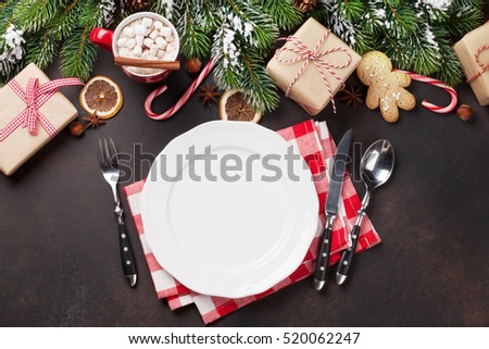 Christmas dinner plate, silverware, fir tree, gift boxes, hot chocolate. Top view with copy space