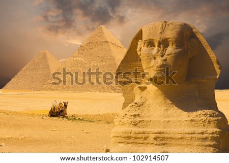 The Great Sphinx's face with a set of pyramids in the background and a beautiful purple sunset sky day in Giza, Cairo, Egypt