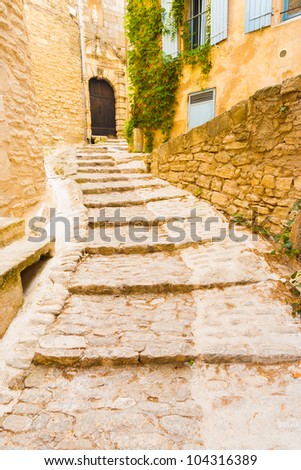 An ancient cobblestone footpath winds its way around the picturesque medievel village of Gordes in Provence, France