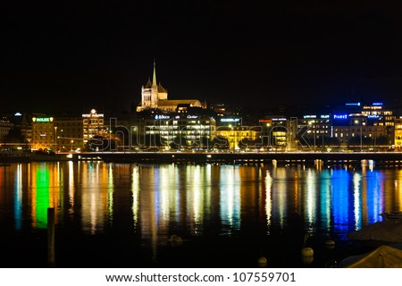 GENEVA, SWITZERLAND - SEPTEMBER 29, 2010: Waterfront luxury brand offices and old town cathedral in Geneva, Switzerland on September 29, 2010. Geneva is a hub of finance and luxury brands.