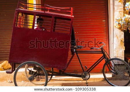 DELHI, INDIA - OCTOBER 27: Unidentified young student rides a shared cycle rickshaw to school on October 27, 2009 in Delhi, India. Shared school buses are not provided by the state in India