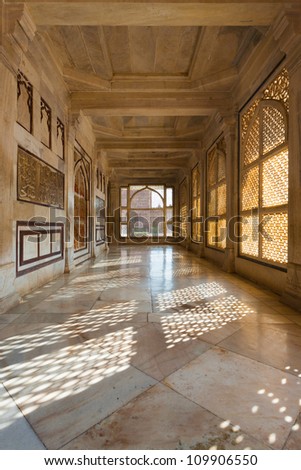 A hallway with beautiful intricate lattice windows in the central white marble tomb of Salim Chishti in the main courtyard at Fatehpur Sikri in Agra, India
