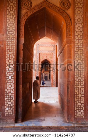 FATEPHUR SIKRI, INDIA - NOVEMBER 18: Muslims pray inside the fort mosque, a famous tourist attraction, for afternoon prayers on November 18, 2009 in Fatephur Sikir, India