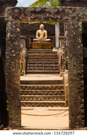 The central stone Buddha statue and steps of the Vatadage are framed by a stone gate at the ancient kingdom capitol of Polonnaruwa, Sri Lanka