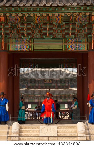 SEOUL, KOREA - SEPTEMBER 17, 2009: Guards in ancient traditional clothes stand at the entrance steps of Gyeongbokgung Palace, the old royal residence, in Seoul, South Korea on September 17, 2009