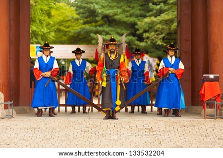 SEOUL, KOREA - AUGUST 27, 2009: Armed guards in traditional costume stand at the entry gate of Deoksugung Palace, a tourist landmark, in Seoul, South Korea on August 27, 2009