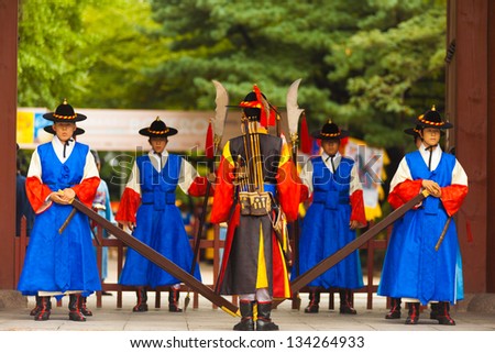 SEOUL, KOREA - AUGUST 27, 2009: Armed soldiers in period costume guard the entry gate at Deoksugung Palace, a tourist landmark, in Seoul, South Korea on August 27, 2009