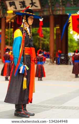 SEOUL, KOREA - AUGUST 27, 2009: A captain in traditional period costume leads the changing of the guards at Deoksugung Palace, a tourist landmark, in Seoul, South Korea on August 27, 2009