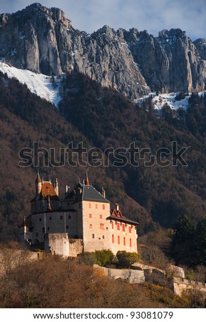 The picturesque fairy tale, Menthon-Saint-Bernard castle at the base of the Alps mountains.  Vertical.