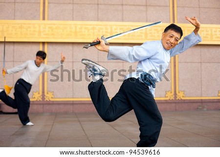 TAIPEI, TAIWAN - AUGUST 13, 2011: Two men in a Tai Chi Chuan stance.  Tai Chi is an ancient martial arts popular in Chinese culture for its positive health effects August 13, 2011 at Taipei, Taiwan