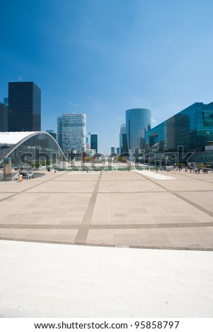 A view down the concourse of La Defense and its office buildings from the steps of the Grande Arche in Paris, France.  Vertical